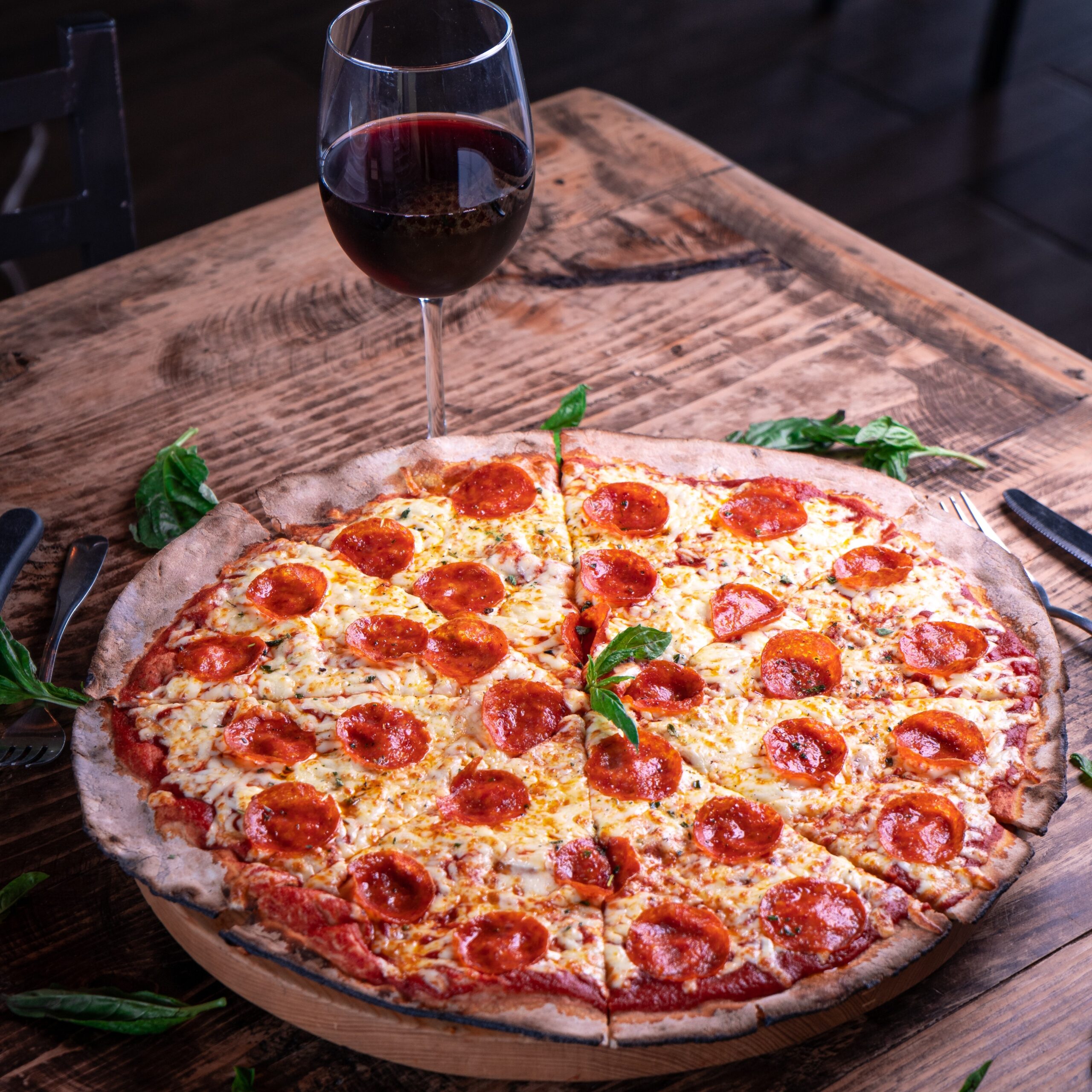vertical shot delicious cheesy pepperoni pizza with glass wine wooden table