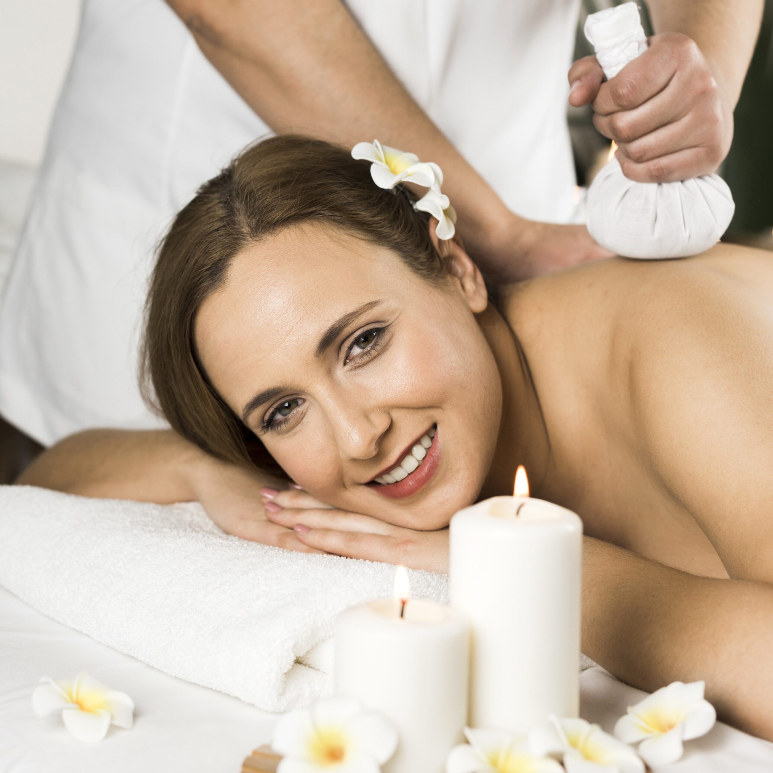 woman receiving massage spa center